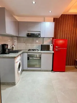 a kitchen with a red refrigerator and a stove at Apartment near Gueliz and Majorelle in Marrakech