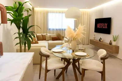 a kitchen and living room with a table and chairs at Le Sahara Retreat - 2 prs - Piscine - Wifi in Marrakech