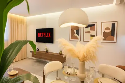 a dining room with a table and a tv at Le Sahara Retreat - 2 prs - Piscine - Wifi in Marrakech
