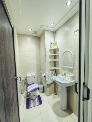 a bathroom with a toilet and a sink at Al Waha Prestige Apartment in Marrakech