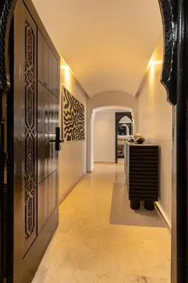 a hallway with a door leading to a kitchen at One bedroom studio in Guéliz, pool & gym in Marrakech