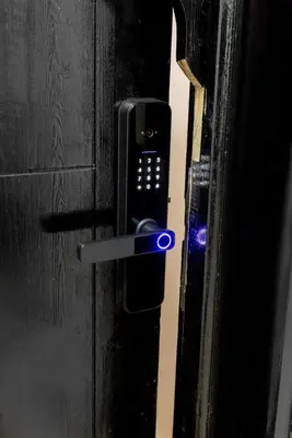 a black door with a cell phone sticking out of it at One bedroom studio in Guéliz, pool & gym in Marrakech