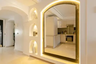 a large mirror in a room with a kitchen at One bedroom studio in Guéliz, pool & gym in Marrakech