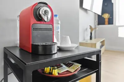 a red mixer sitting on top of a table at Centre Town Cozy Apartment with Panoramic View in Marrakech