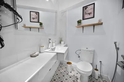 a white bathroom with a toilet and a sink at Centre Town Cozy Apartment with Panoramic View in Marrakech