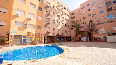 a swimming pool in the middle of a building at Appartement Chic avec Piscine au Cœur de Gueliz in Marrakech