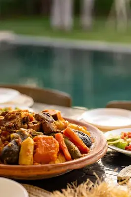 a plate of food on top of a table at Momiji Golf Villa - Private Heated Pool in Marrakech