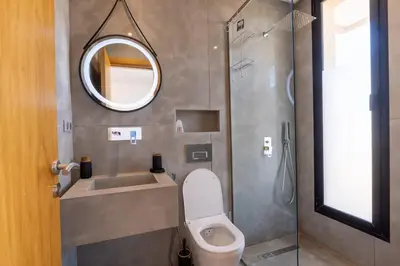 a bathroom with a toilet and a sink and a mirror at Momiji Golf Villa - Private Heated Pool in Marrakech