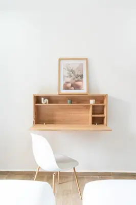 a wooden shelf on a wall with a white chair at Menara Suite Harmonie , Terrasse et Piscine in Marrakech