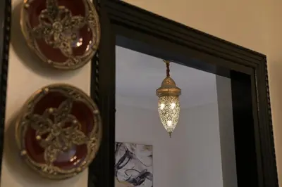 a reflection of a chandelier in a mirror at Villa Sara - 3 Rooms with private pool in Marrakech