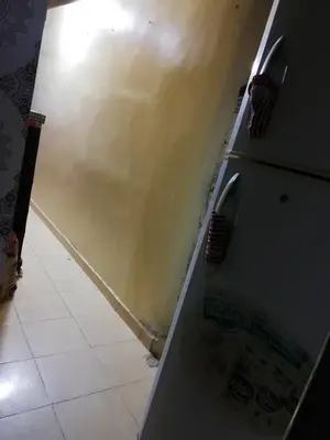 a kitchen with a wall and a tile floor at famile 154 in Marrakech