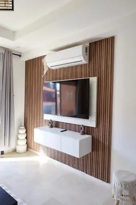 a living room with a television on a wall at Cosy appartement , Marrakech Noria golf in Marrakech
