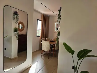 a dining room with a mirror and a table at Amber Haven in Marrakech