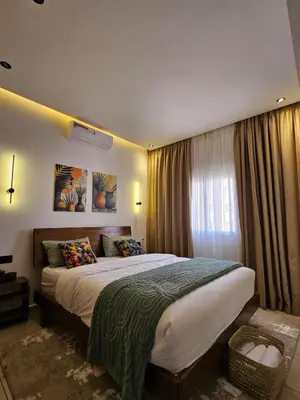 a bedroom with a large bed and a window at Amber Haven in Marrakech