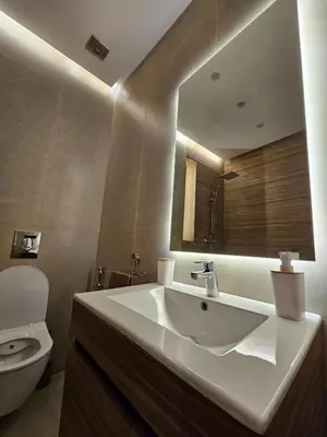 a bathroom with a sink and a toilet and a mirror at Amber Haven in Marrakech