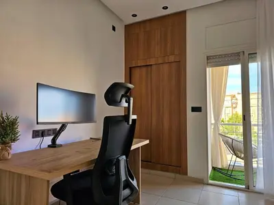 a office with a desk with a chair and a monitor at Amber Haven in Marrakech
