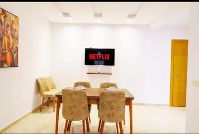 a dining room with a table and chairs at Luxury apartment in Hivernage in Marrakech