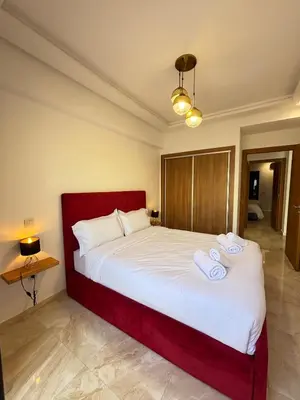 a bedroom with a large bed with two towels on it at Cozy opera - Hivernage - Gare in Marrakech
