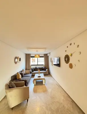 a living room with a couch and a table at Cozy opera - Hivernage - Gare in Marrakech