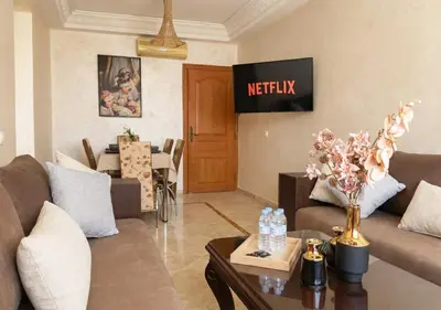a living room with a couch and a table at Andalous Prestige in Marrakech