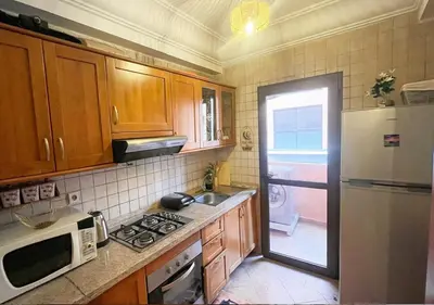 a kitchen with a white refrigerator and a microwave at Andalous Prestige in Marrakech