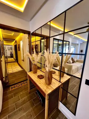 a living room with a table with plants on it at Appartement Luxe 2 Chambres Guéliz Centre Calme & Prestations Haut de Gamme in Marrakech