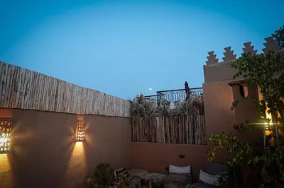 a courtyard of a house at night with a fence at Riad Amara Private pool breakfast in Marrakech