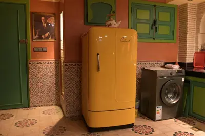 a yellow refrigerator in a kitchen next to a washing machine at Riad Marrakech 88 Retro Chic 3 Rooms with Shared Pool in Marrakech
