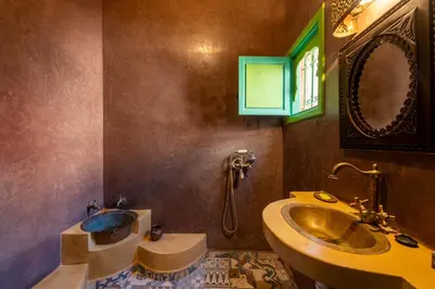 a bathroom with a sink and a tub and a mirror at Riad Marrakech 88 Retro Chic 3 Rooms with Shared Pool in Marrakech