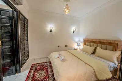 a bedroom with a large bed in a room at Riad Marrakech Golden Star 82 with 3 Rooms & Pool in Marrakech