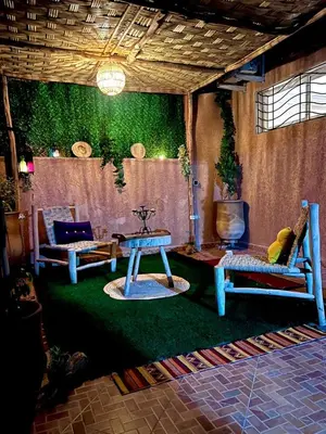 a living room with two chairs and a table at Adomar Lighted Terrace Retreat, 2BR Comfort in Marrakech