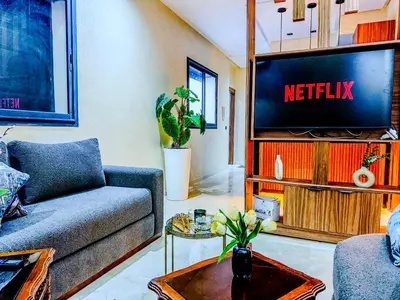a living room with a couch and a tv at Modern Studio Menara Garden in Marrakech