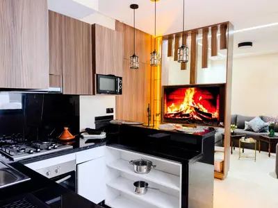 a kitchen with a stove and a fireplace at Modern Studio Menara Garden in Marrakech