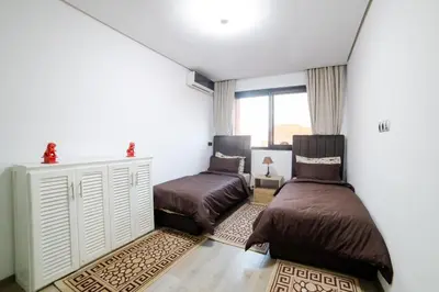 a bedroom with two beds and a window at Appartemment top Marrakech in Marrakech