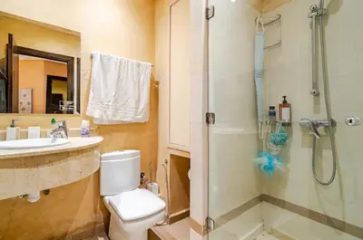 a bathroom with a shower and a toilet and a sink at Appartement marrakech garden in Marrakech