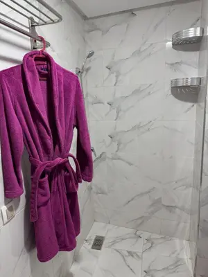 a purple towel is hanging in a bathroom at Gueliz Bright & Modern 2BR 2 Balcons in Marrakech
