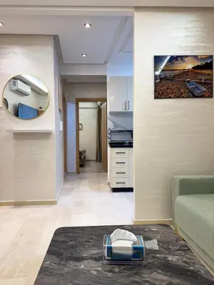 a living room with a couch and a mirror at Gueliz Bright & Modern 2BR 2 Balcons in Marrakech