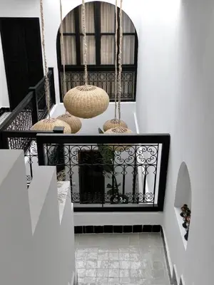 a hallway with three baskets hanging from a rail at Riad Costa 2 privates pools rooftop breakfast in Marrakech