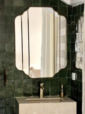 a bathroom with a large mirror over a sink at Riad Costa 2 privates pools rooftop breakfast in Marrakech