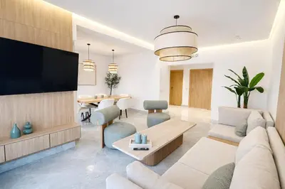 a living room with a couch and a tv at Luxury 2 Bedroom Apartment Pool & Garden Wifi in Marrakech