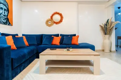 a living room with a blue couch and a coffee table at Bright & Chic Stay in Marrakech Gueliz in Marrakech
