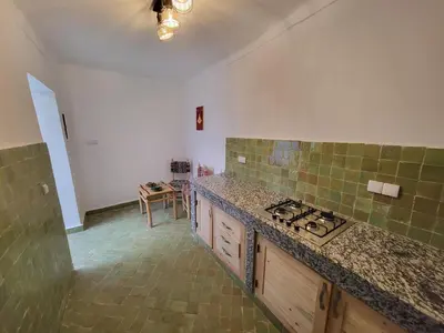 a kitchen with a stove and a counter top at Riad Granada in Marrakech