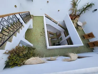a room with stairs and a mirror and plants at Riad Granada in Marrakech