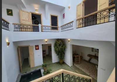 two levels of a house with a plant in the middle at Riad Granada in Marrakech