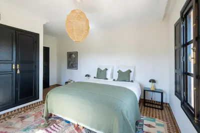 a bedroom with a large bed and a large window at Magnifique Villa EME, Golf Amelkis Marrakech - Piscine Chauffée in Marrakech