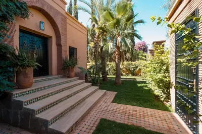 a courtyard with stairs leading to a building at Magnifique Villa EME, Golf Amelkis Marrakech - Piscine Chauffée in Marrakech