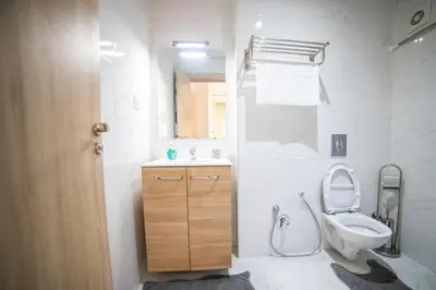 a white bathroom with a toilet and a sink at Les cristaux de Marrakech in Marrakech