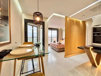 a bathroom with a glass table and a bedroom at Verona Studio - 1 Bedroom Piscine & Rooftop in Marrakech
