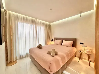 a bedroom with a large bed with two teddy bears on it at Verona Studio - 1 Bedroom Piscine & Rooftop in Marrakech