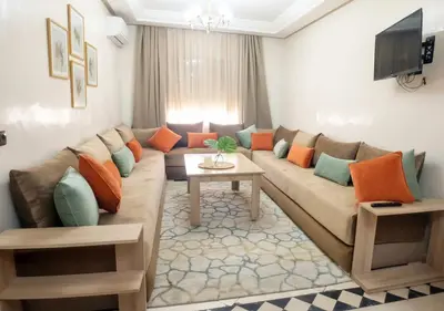 a living room with a couch and a table at Appart Mobarak 5 in Marrakech